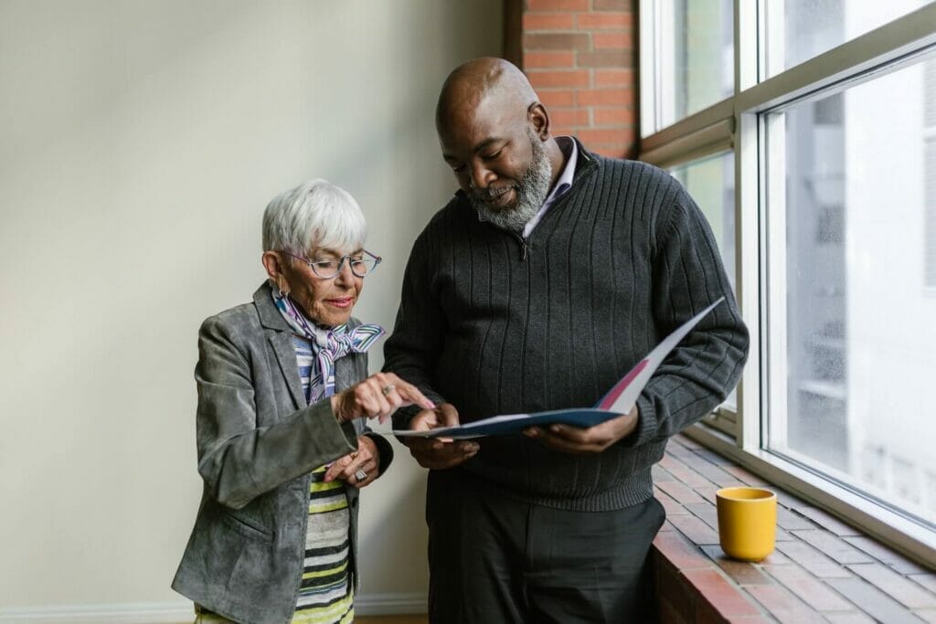 A senior professional explains a concept to a younger colleague.