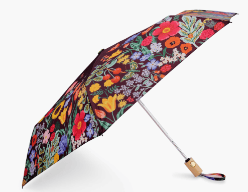 Product image of an expandable umbrella with a wooden handle and floral and black background umbrella design.